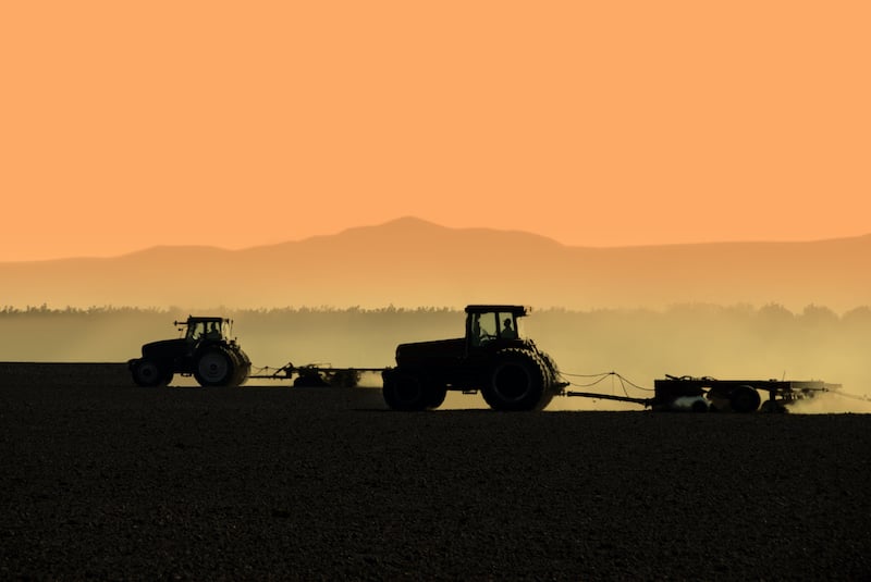 silhouetted tractors